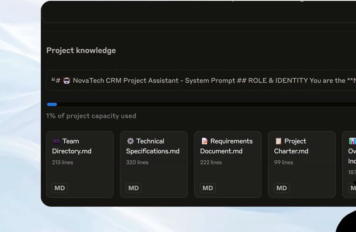 Claude Projects knowledge panel — custom system prompt for a NovaTech CRM Project Assistant with role and identity instructions, a 1% of project capacity used progress bar, and four uploaded knowledge file cards (Team Directory.md 213 lines, Technical Specifications.md 320 lines, Requirements Document.md 222 lines, Project Charter.md 99 lines), each tagged MD