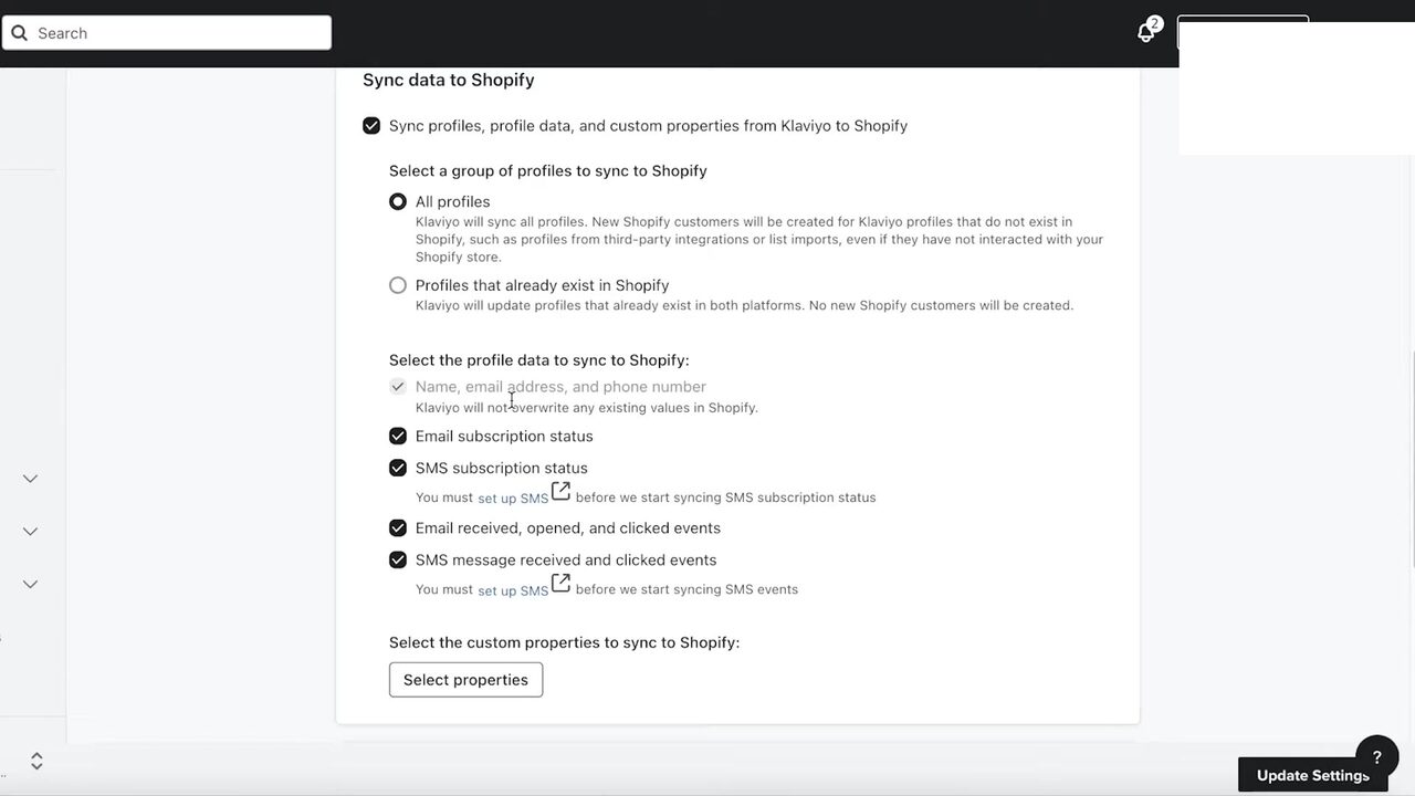 Klaviyo's Sync data to Shopify integration settings page. The lone parent toggle Sync profiles, profile data, and custom properties from Klaviyo to Shopify is on. Beneath it, a Select a group of profiles to sync radio group offers All profiles (selected, with explainer that new Shopify customers will be created from third-party imports) versus Profiles that already exist in Shopify (update only). A Select the profile data to sync to Shopify checklist enables Email subscription status, SMS subscription status, Email received/opened/clicked events, and SMS message received/clicked events, with inline set up SMS links flagged as prerequisites. Below sits a Select properties button for custom property syncing, and the bottom-right Update Settings button commits the config.